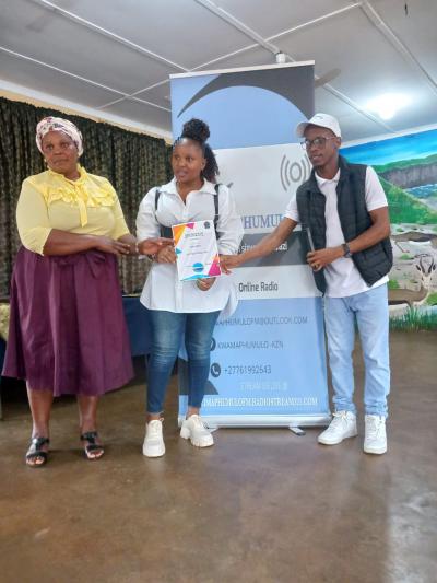 Sanele Ngcomo and Her parent receiving their award